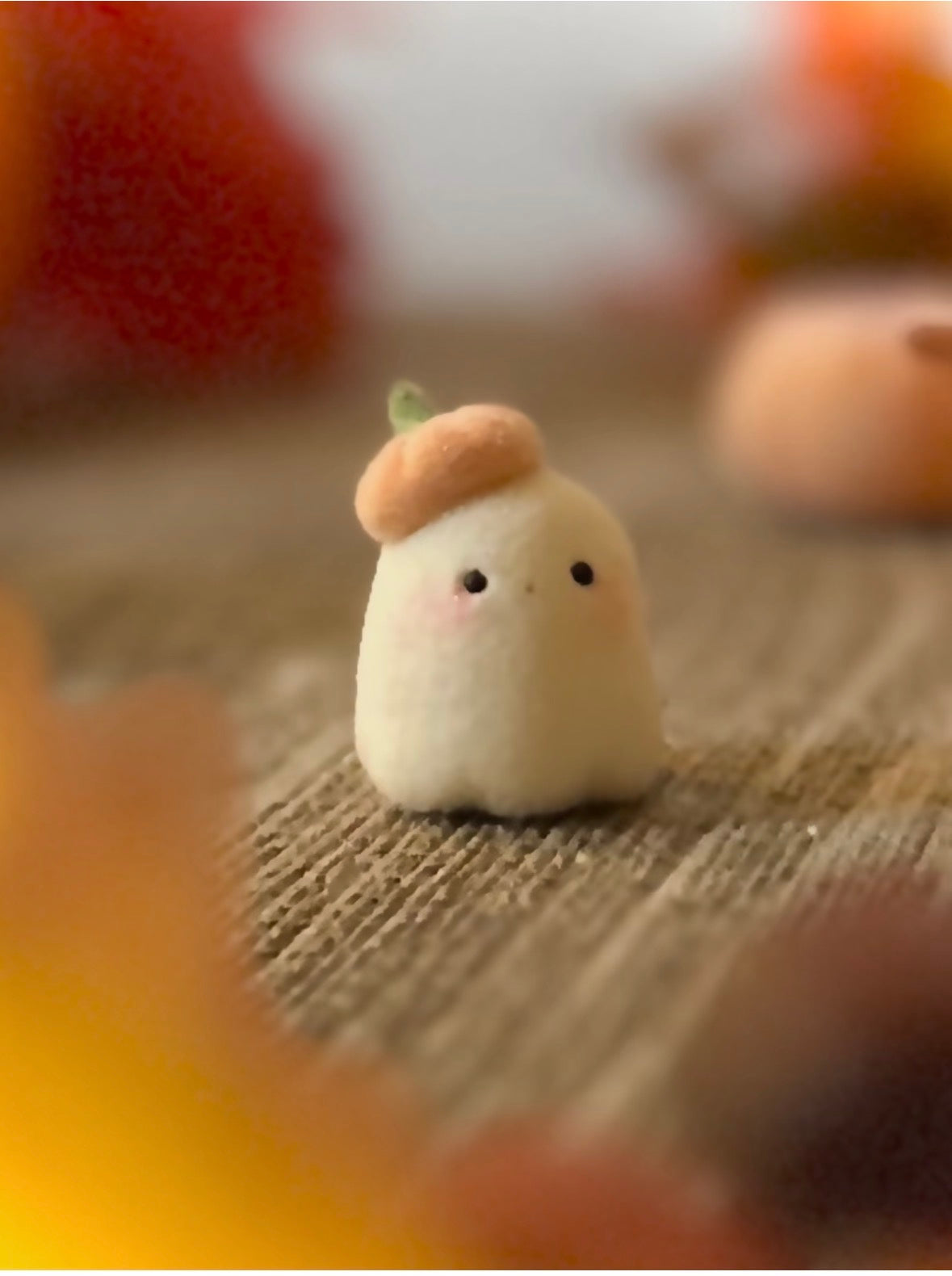 Bookin  2 inch flocked, clay figurine with wooden base.