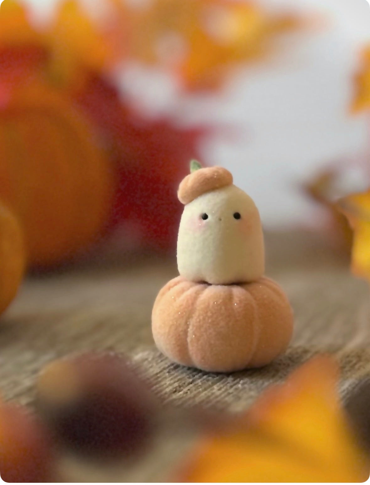 Bookin  2 inch flocked, clay figurine with wooden base.