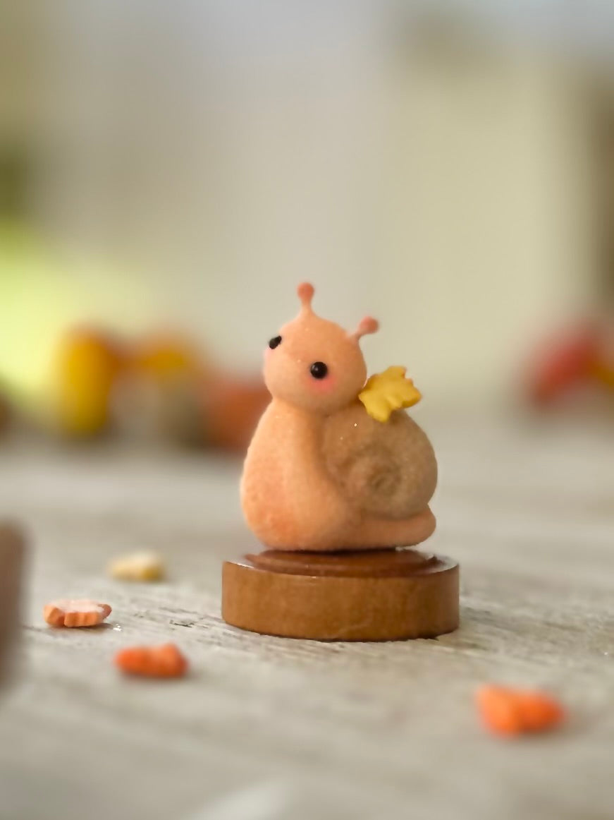 Fall snail 1.5 inch flocked, clay figurine with wooden base.