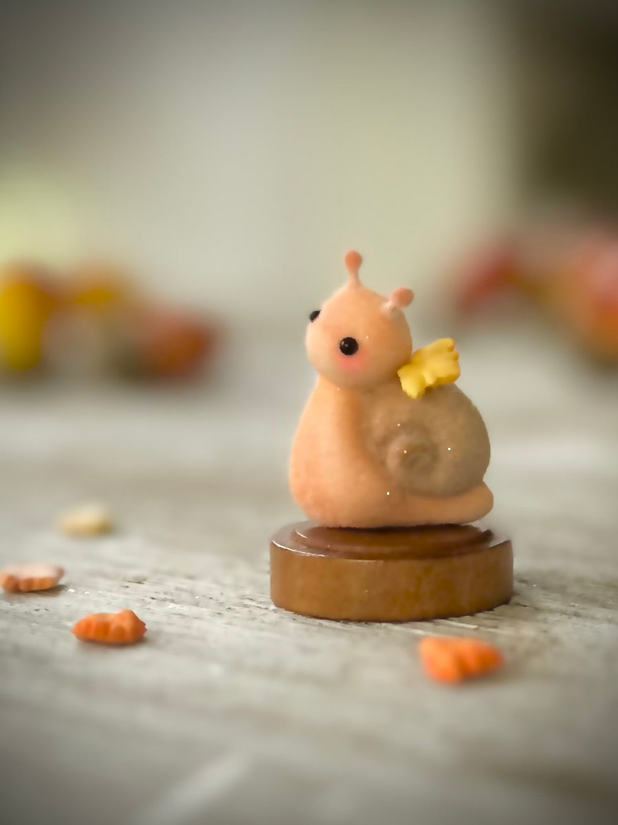 Fall snail 1.5 inch flocked, clay figurine with wooden base.