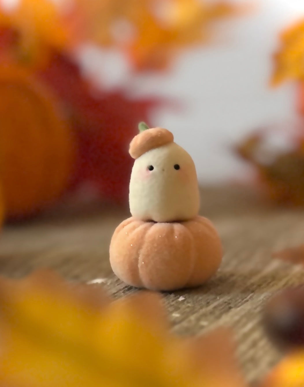 Bookin  2 inch flocked, clay figurine with wooden base.
