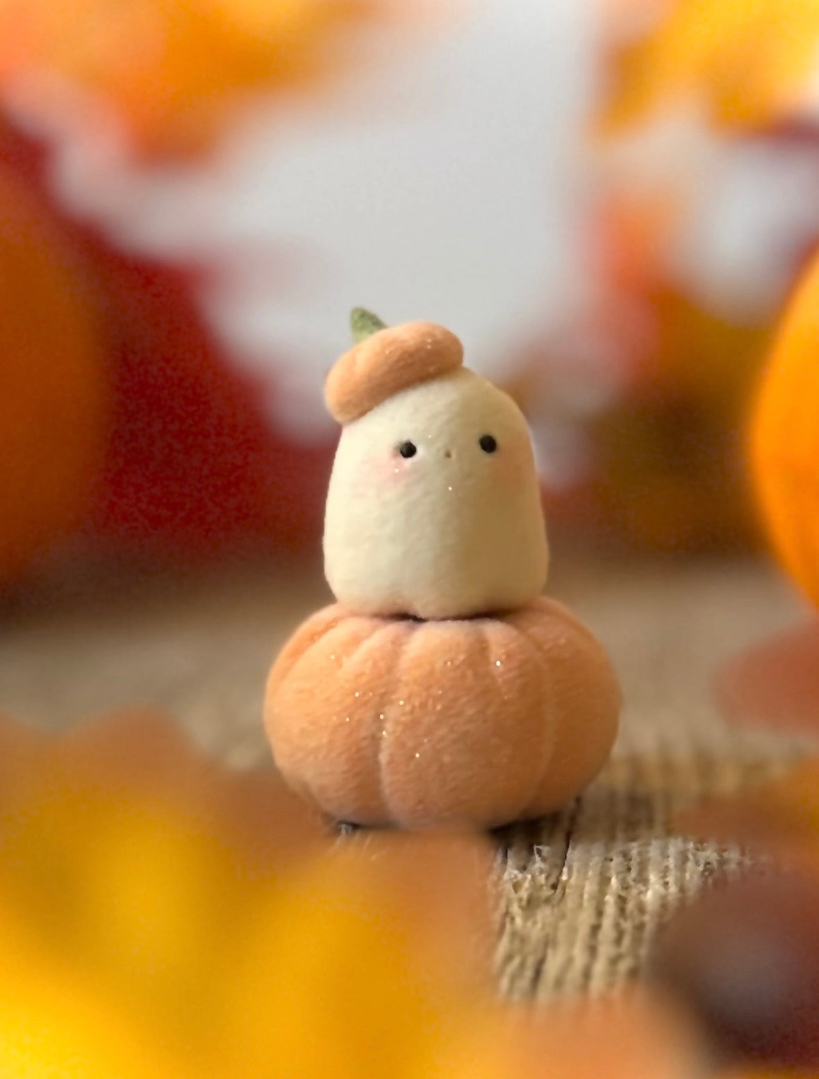 Bookin  2 inch flocked, clay figurine with wooden base.