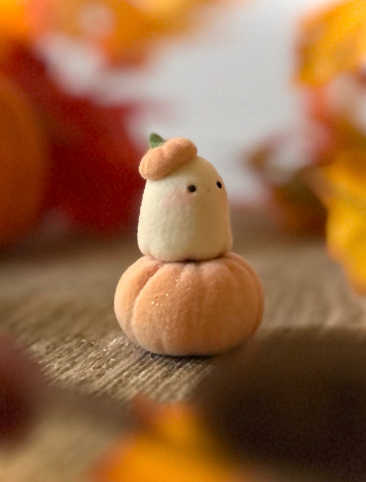 Bookin  2 inch flocked, clay figurine with wooden base.