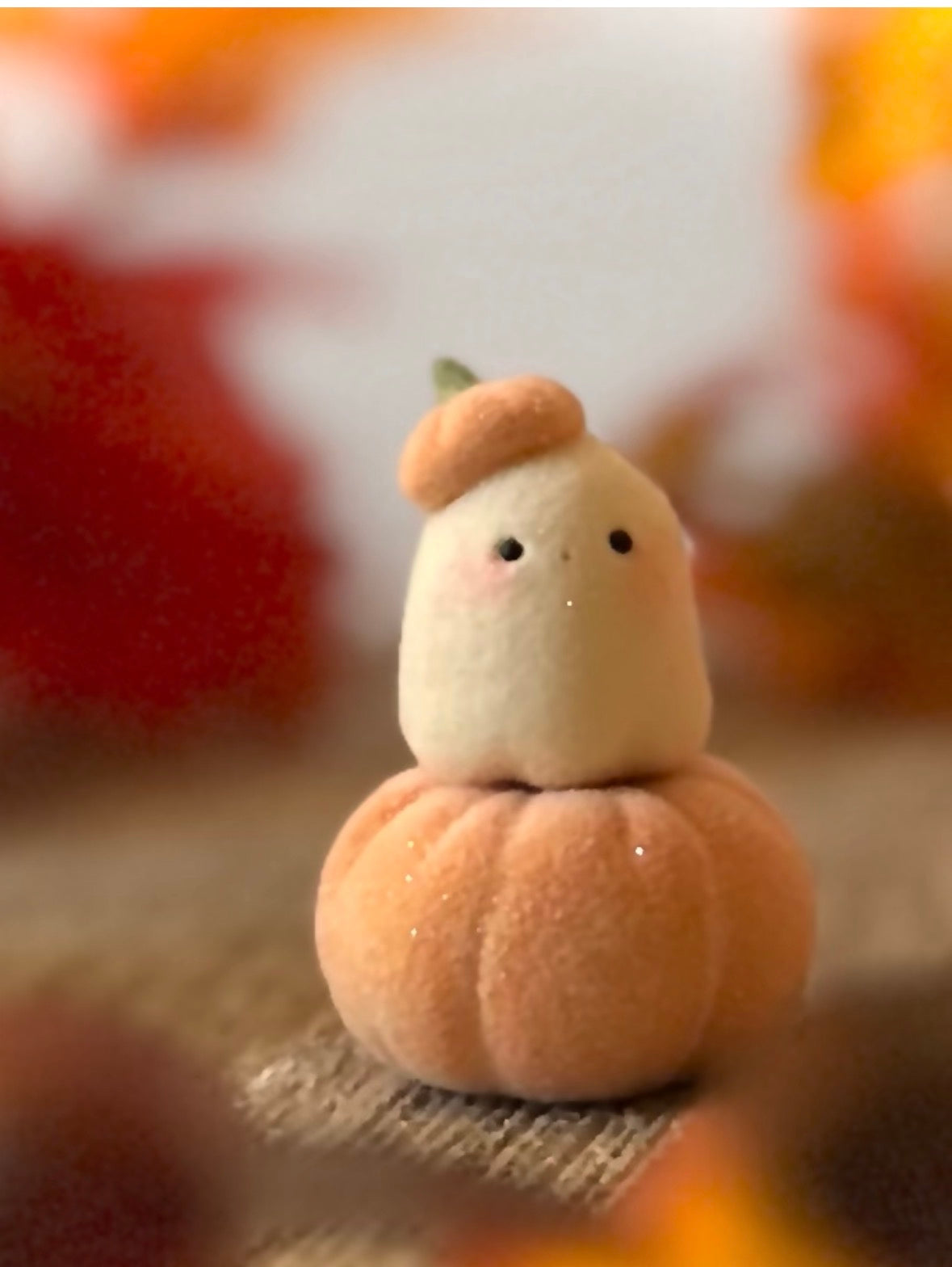 Bookin  2 inch flocked, clay figurine with wooden base.